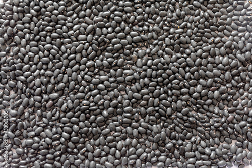 A background texture of many dried black beans