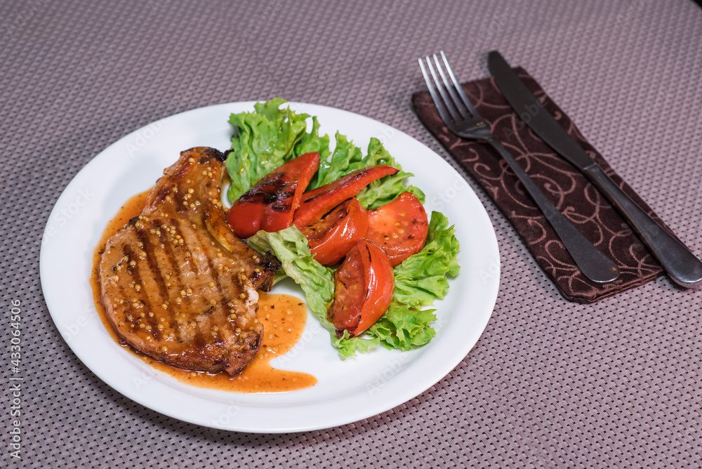 Pepper steak with grilled vegetables on a table in a restaurant. Oriental cuisine Pepper steak with grilled vegetables on a table in a restaurant. Oriental cuisine