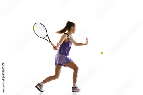 Young caucasian woman playing tennis isolated on white studio background in action and motion, sport concept © master1305