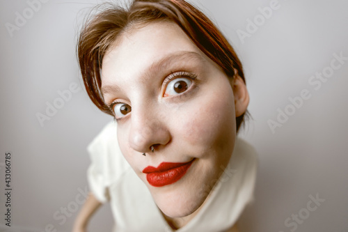 Photos Funny portrait of a girl close-up, Looking with big eyes into the camera