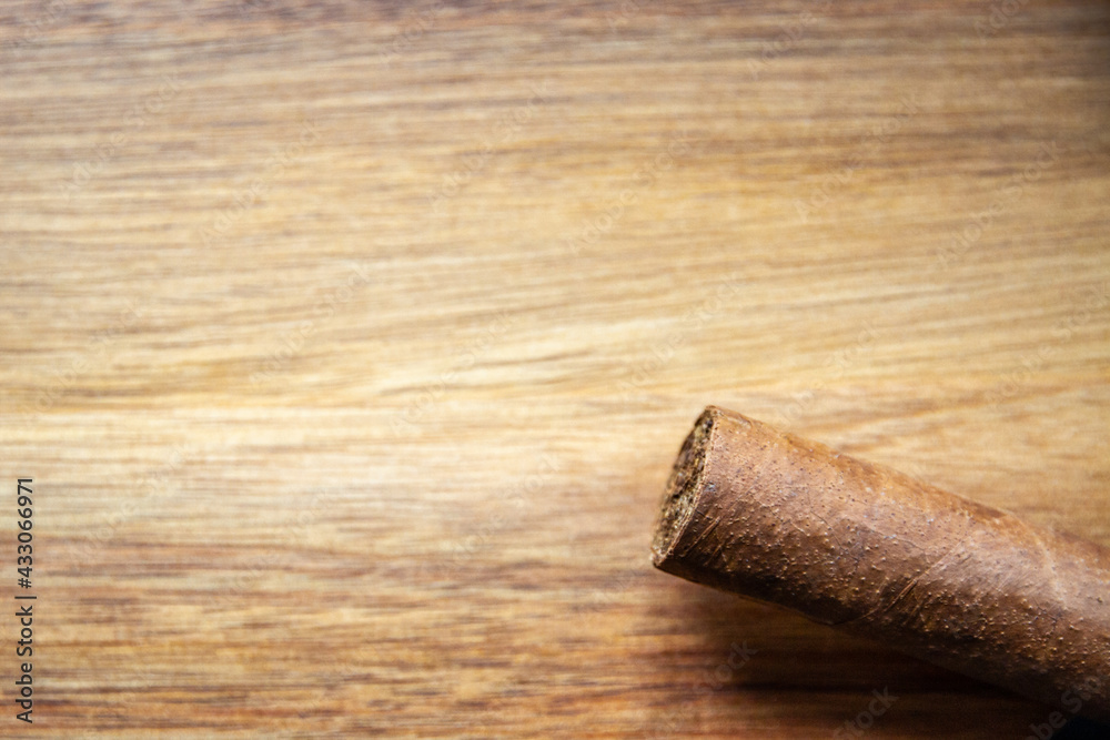 Brown cuban cigar on wooden background