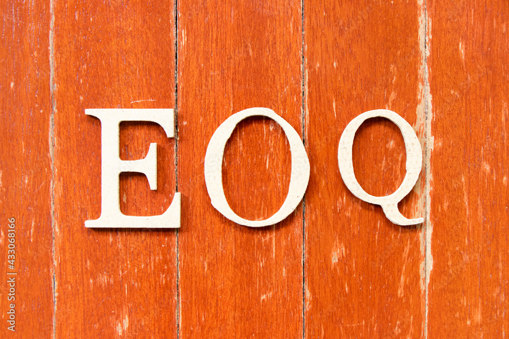 Alphabet letter in word EOQ (Abbreviation of Economic order quantity) on old red color wood