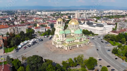 Alexander Nevsky Cathedral, Sofia, Bulgaria. Orthodox church built in Neo-Byzantine style and city view. Beautiful scene of byzntine religion building took with aerial drone 4K 30fps.