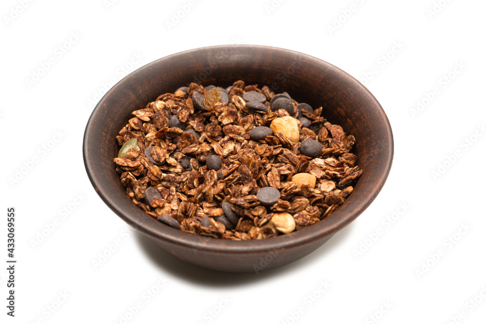 Chocolate granola cereal with nuts in a bowl background. Chocolate granola cereal with nuts in a bowl background.