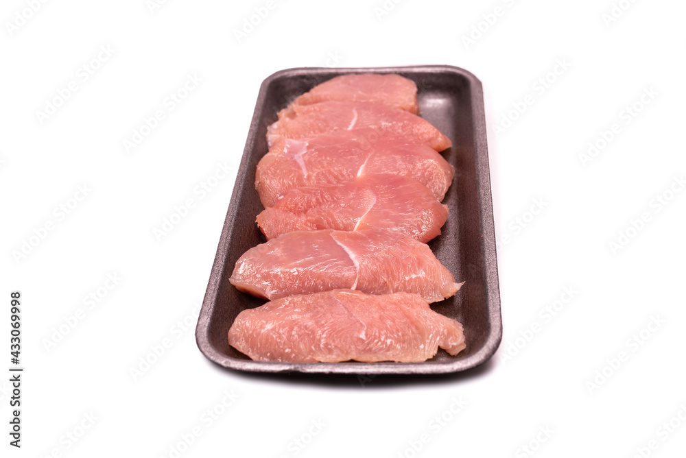 Turkey fillet in a black plastic container isolated. Turkey fillet in a black plastic container isolated.