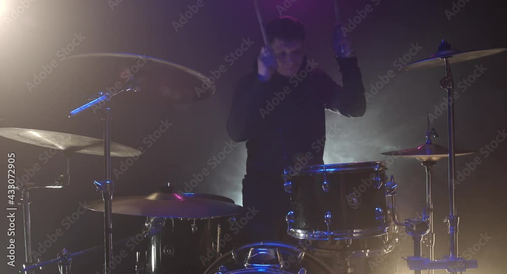 The guy hits the drums hard The guy hits the drums hard