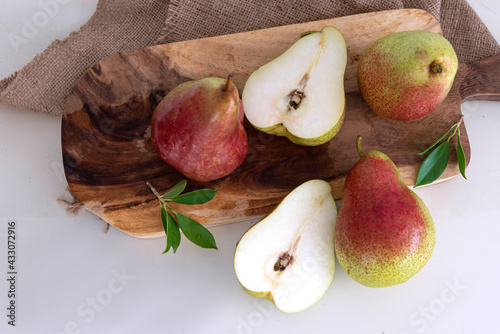Ripe red pears with logo put on handmade cloth white background.