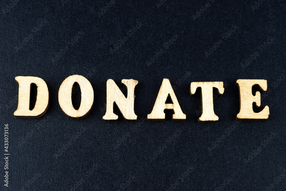 The word donate made from wooden cubes. Conceptual photo. Top view The word donate made from wooden cubes. Conceptual photo. Top view