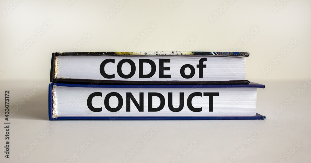 Code of conduct symbol. Concept words 'Code of conduct' on books on a beautiful white table, white background. Business and code of conduct concept. Copy space.