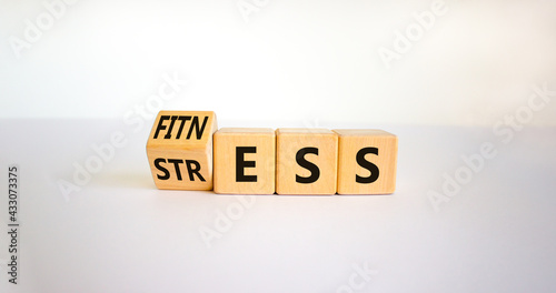 Fitness vs stress symbol. Turned the cube and changed the word 'stress' to 'fitness'. Beautiful white background. Medical, psychological, fitness vs stress concept. Copy space. photo