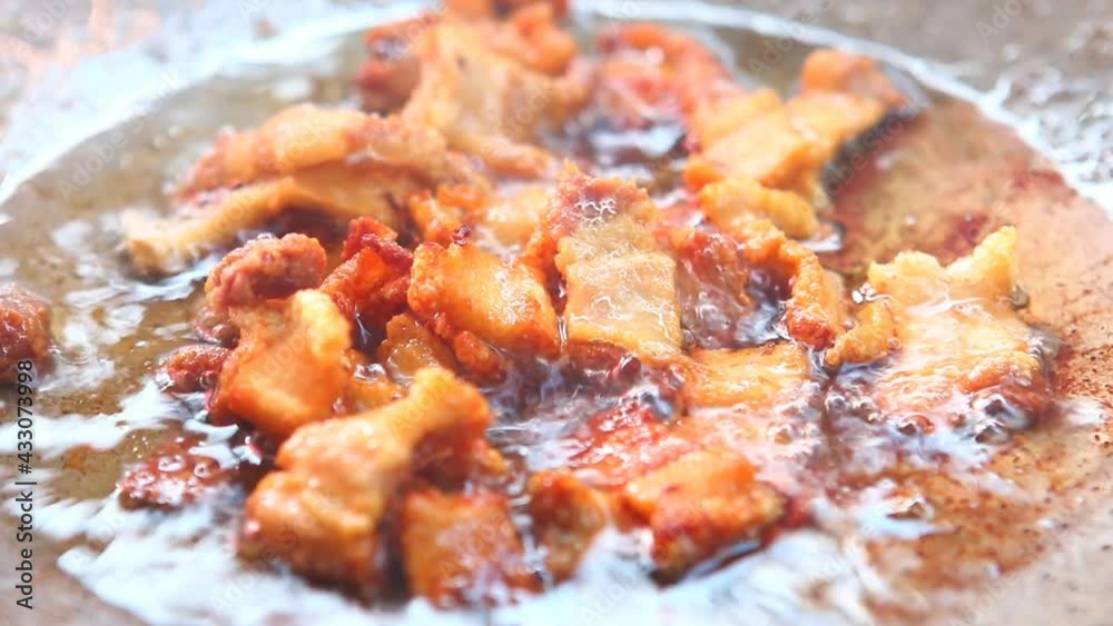 Frying chopped pork belly in pan , in door Chiangmai Thailand Frying chopped pork belly in pan , in door Chiangmai Thailand
