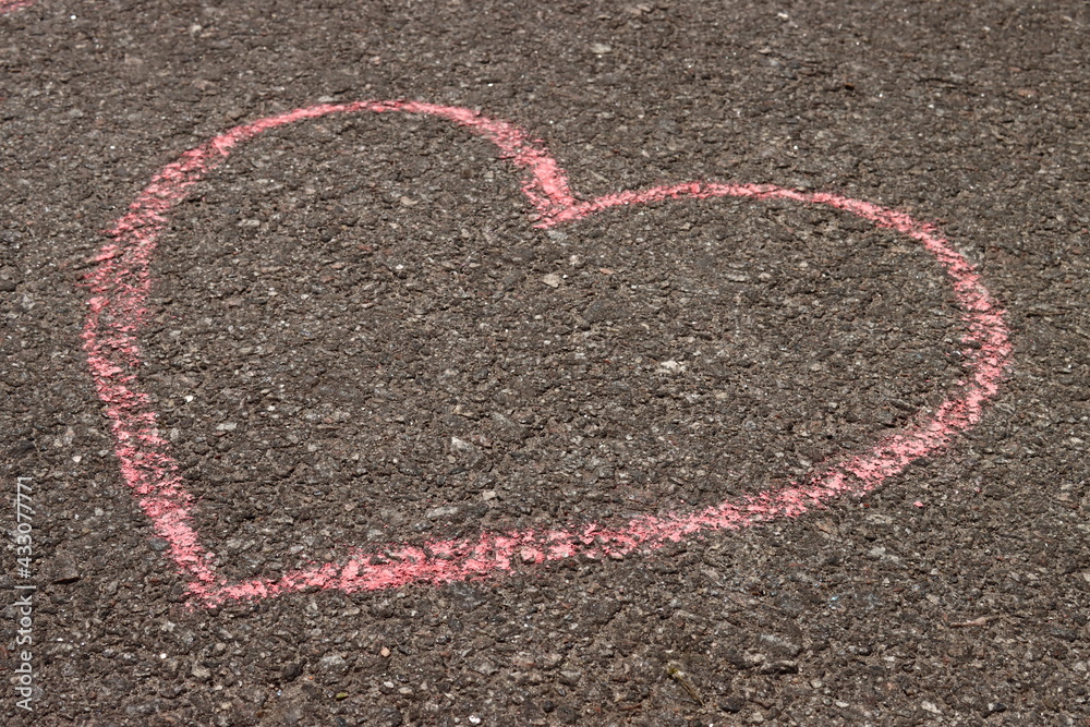 heart in chalk on the asphalt, children's drawing on the sidewalk heart in chalk on the asphalt, children's drawing on the sidewalk