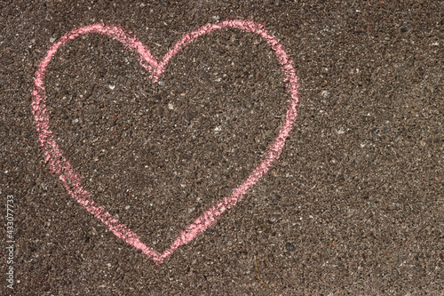 heart in chalk on the asphalt, children's drawing on the sidewalk