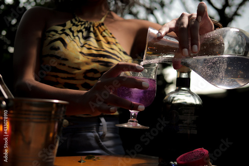 Black woman having Brazilian drink with fruit