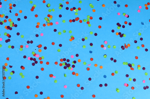 Texture background of colored confetti on a blue background
