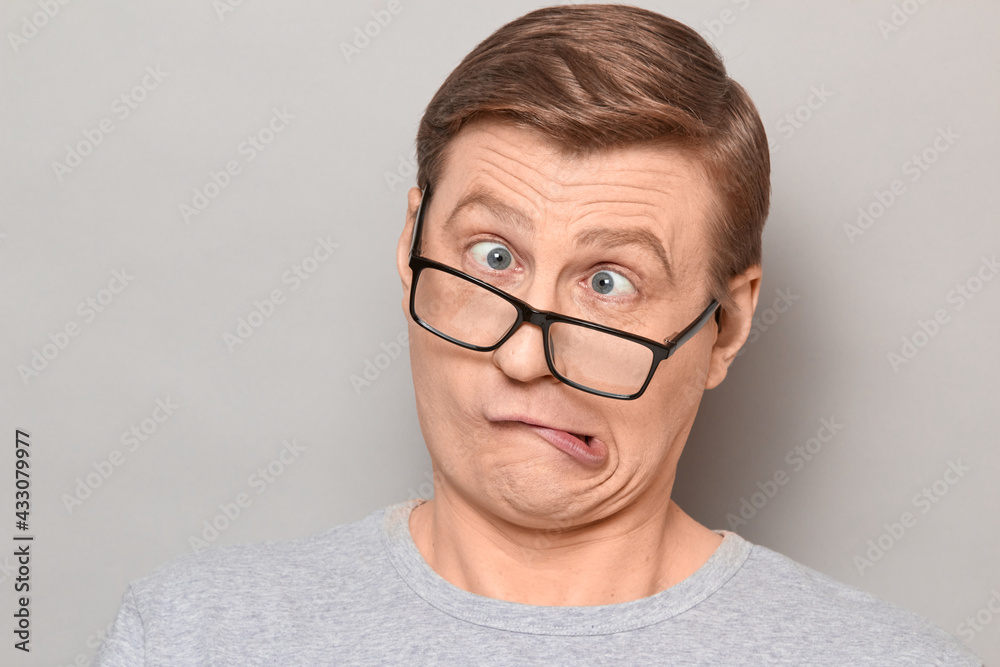 Portrait of funny weird mature man making goofy crazy face Portrait of funny weird mature man making goofy crazy face