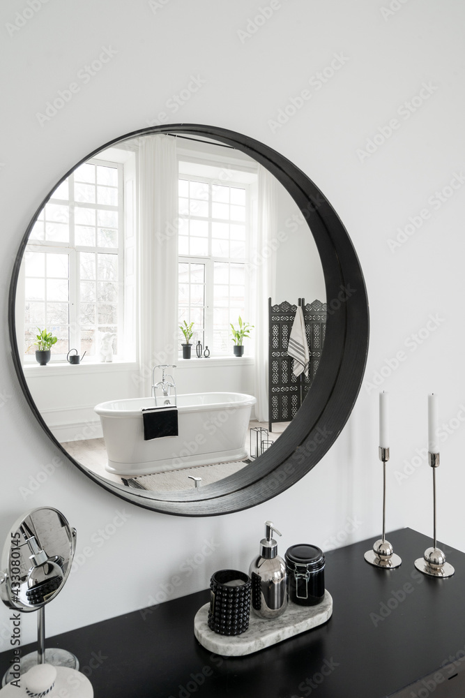 Makeup table and round mirror in contemporary bathroom Makeup table and round mirror in contemporary bathroom