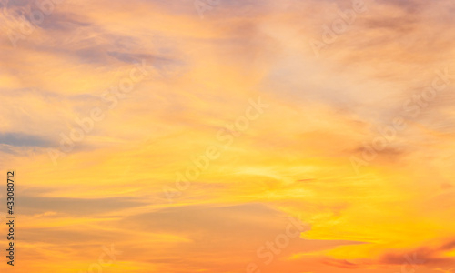 Sunset sky with orange sunlight in the evening summer season, dusk sky background 