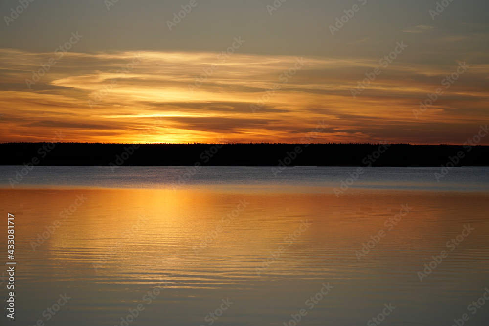 Sunset on the Plavno lake in the Berezinsky nature reserve. Horizon and reflection. Red paints a bright sky. Belarusian landscape.