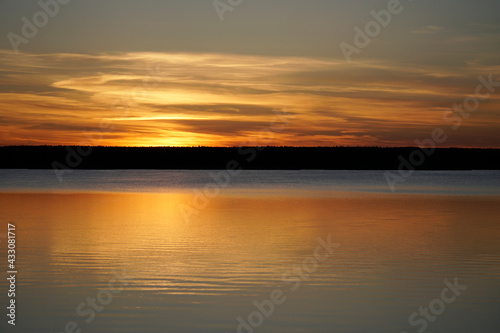 Sunset on the Plavno lake in the Berezinsky nature reserve. Horizon and reflection. Red paints a bright sky. Belarusian landscape. © Anatoliy