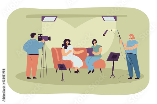 People recording interview in studio. Flat vector illustration. Host, guest person and crew of videographers with cameras filming interview for tv show, news report. Broadcasting, interview concept