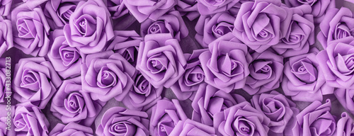 banner with background of purple or lilac flowers. fake flowers. Artificial purple or lilac roses  foamiran roses.