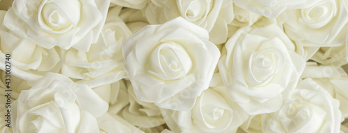 banner with background of white fake flowers. Artificial white foamirane roses.