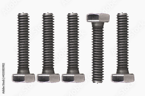 Abstract figure of gray metal screws, created with photographs of screws by photo composition on white background, all screws face up, except one, which faces down.