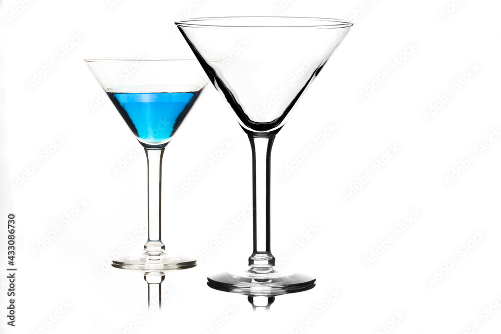 Martini glasses isolated on white with blue drink in one glass Martini glasses isolated on white with blue drink in one glass