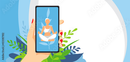 Woman in yoga pose on the smartphone screen. A woman's hand holds a phone. Horizontal flyer with leaves.