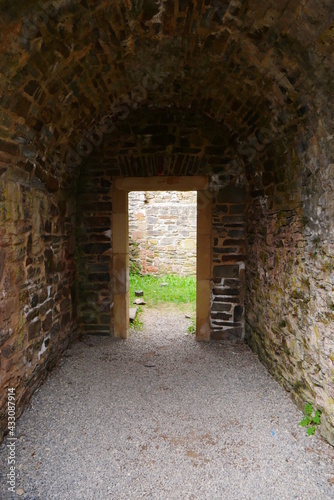 Passage hall with vaulted ceiling with door of an old ruined castle from the Middle Ages