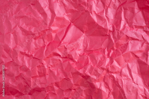 Texture of red crumpled paper. Top view.