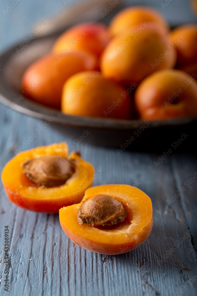 Fresh apricots on blue background. Close up. 