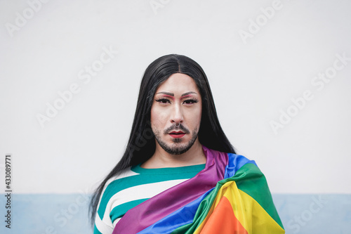 Transgender person looking serious in camera at gay pride parade