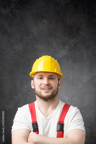 Happy, smiling worker with arms crossed looking at camera