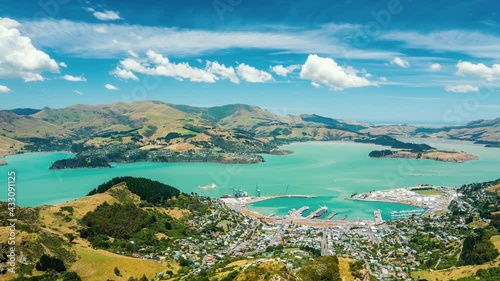 Clouds motion fast over Lyttelton Harbour bay in beautiful New Zealand nature countryside in sunny summer landscape Time lapse photo
