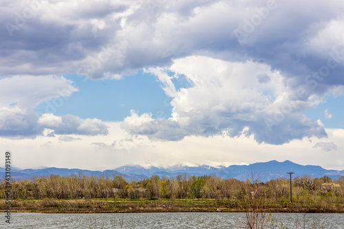 Colorado landscape near Brighton, Colorado. Small pond and grass with the Long Peek view in the distance