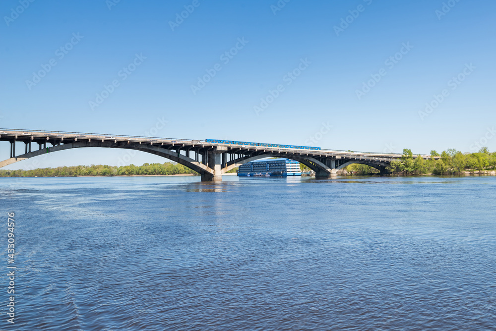 View from the Dnieper River in Kiev to the metro train. Horizon train on the bridge
