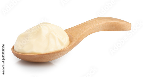 mayonnaise in a special wooden spoon for sauces isolated on white