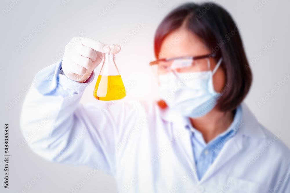 Woman scientist or chemist research in protective mark and glasses looking at sample in laboratory, Medical health care analysis process business concept. Woman scientist or chemist research in protective mark and glasses looking at sample in laboratory, Medical health care analysis process business concept.