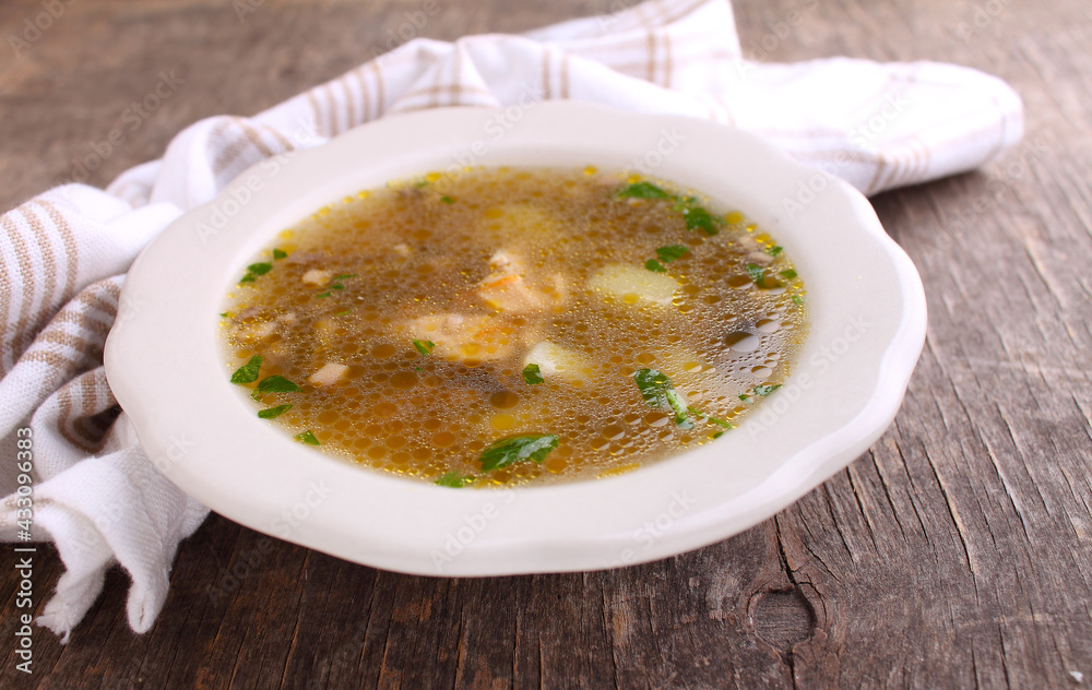 Mushroom soup with chicken and barley. Decorated with greenery. On an old wooden background. Mushroom soup with chicken and barley. Decorated with greenery. On an old wooden background.