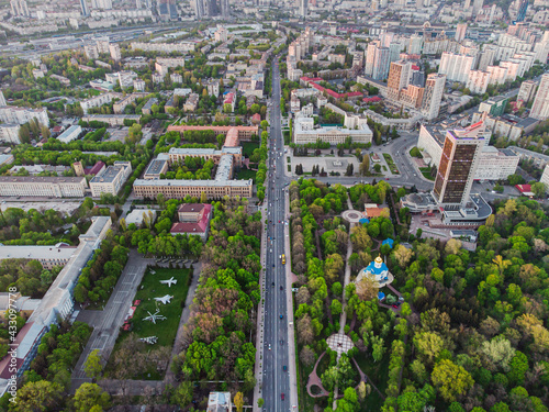 Aerial view of a straight road at green city with the exhibition of military aviation and park area in Kyiv/Kiev city, capital of Ukraine