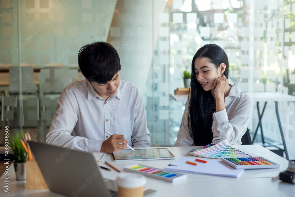 Team Asian designer people made graphics using a tablet with a color sample at the office. Team Asian designer people made graphics using a tablet with a color sample at the office.