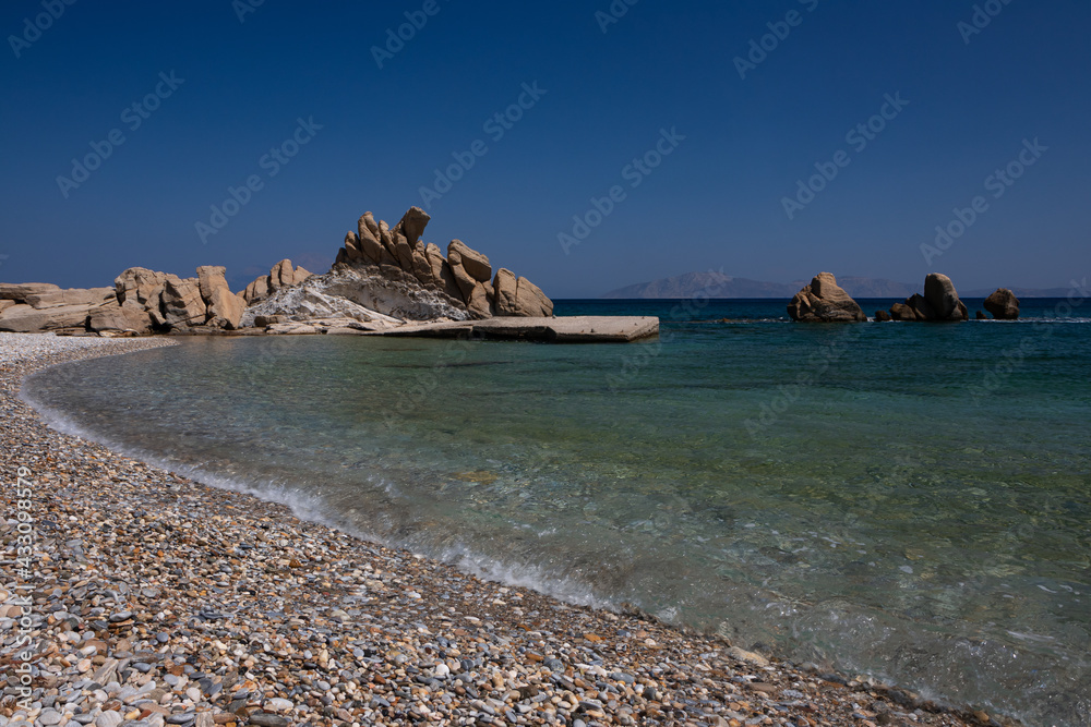 Beautiful pebble beach with wild rock formations at Kerame beach.