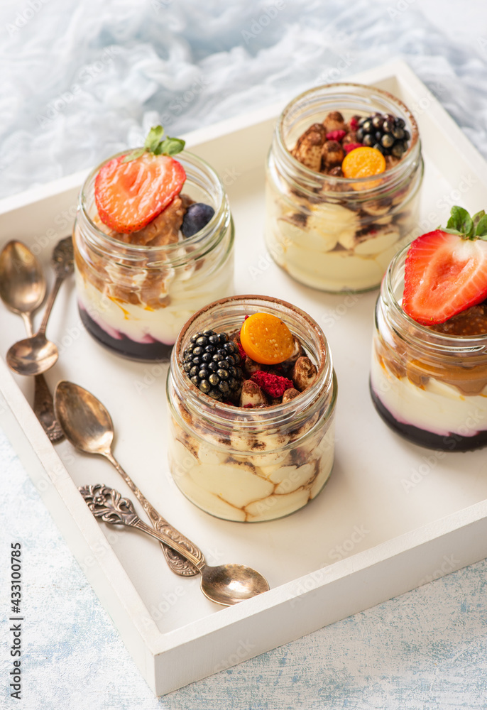 Homemade tiramisu dessert in glass jars. Homemade tiramisu dessert in glass jars.