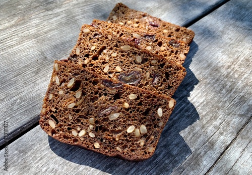 Wallpaper Mural Sliced pieces of bread with seeds on a wooden background. Torontodigital.ca