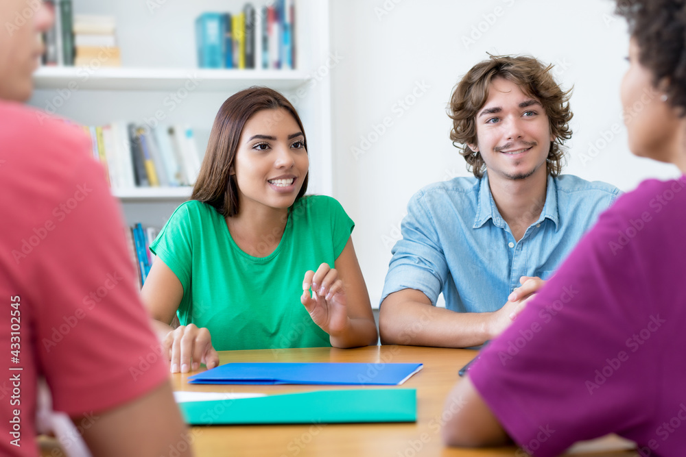 Latin and caucasian male and female students learning for exam Latin and caucasian male and female students learning for exam