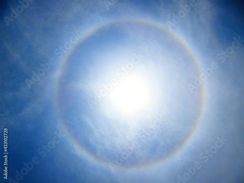 Fototapeta Naklejka Na Ścianę i Meble -  A 360-degree rainbow formed around the sun during midday as seen from ground