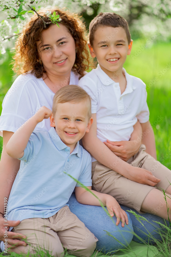 picnic. mother with sons in flowering garden. mother's day picnic. mother with sons in flowering garden. mother's day