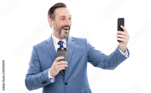 happy man blogger in suit meking selfie on phone and drink coffee isolated on white, video call. photo